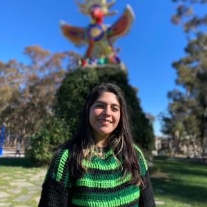 Juli Avalos at UCSD with Sun god statue in background