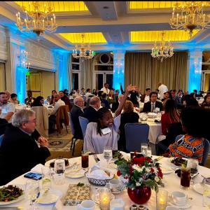 LA Holiday Dinner Alumni raised hand