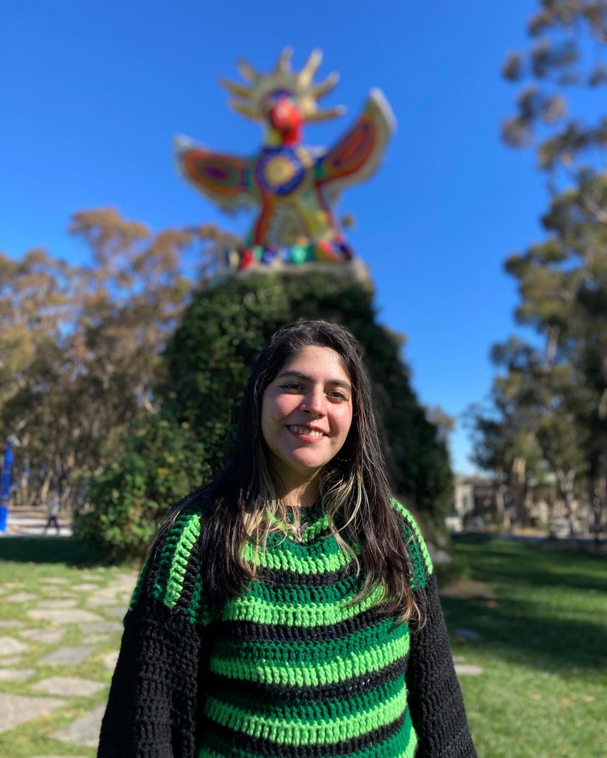 Juli Avalos at UCSD with Sun god statue in background